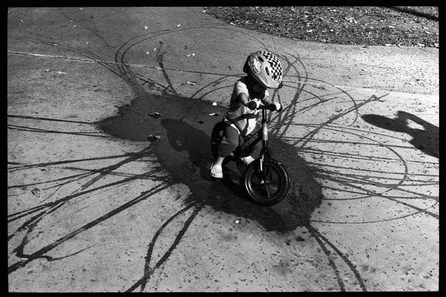 street-photography-scanning-film-benefits-Roll-17-Kid-on-Bike-in-Puddle-Tavis-Leaf-Glover-55